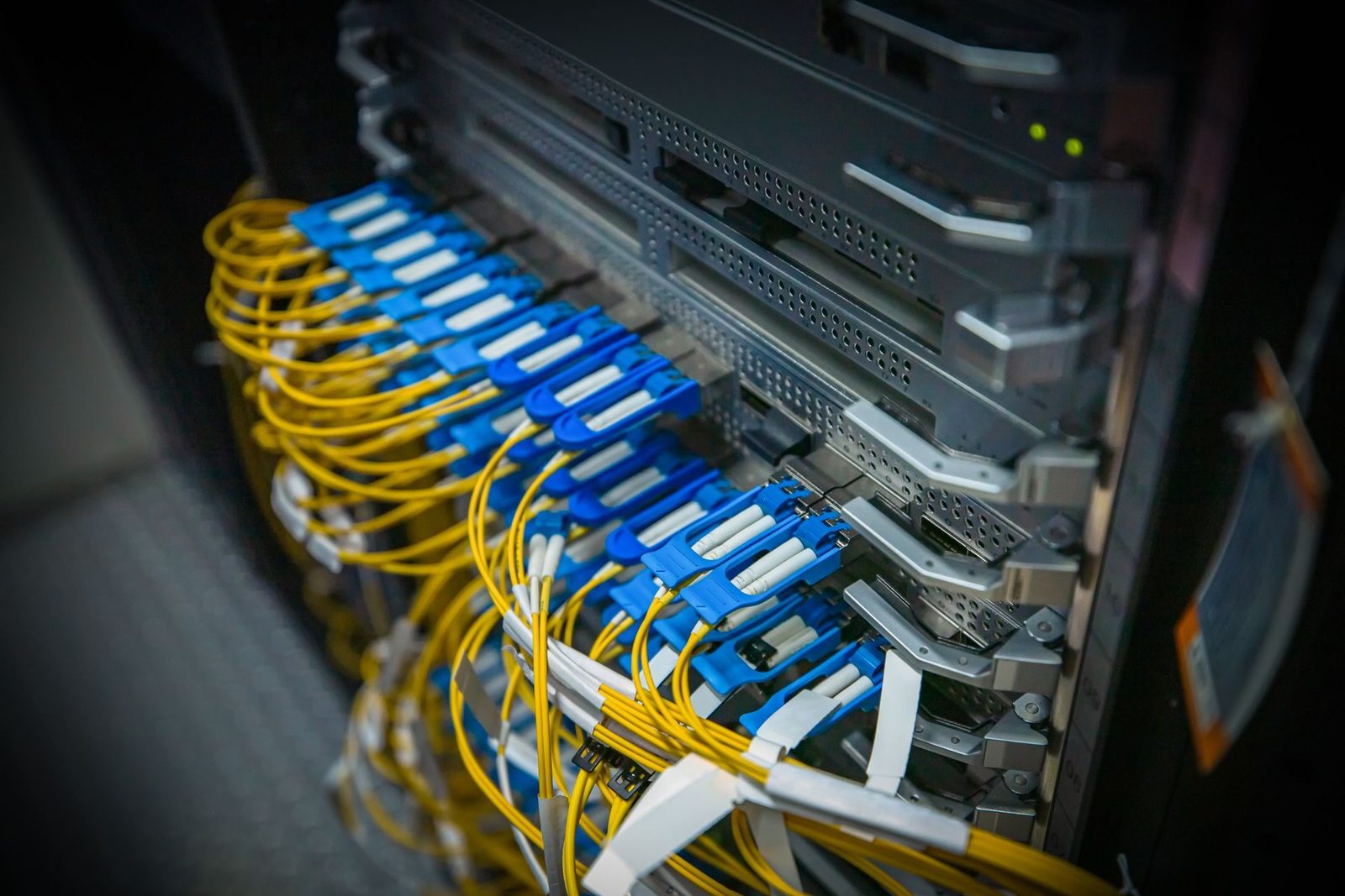 Armadio rack con cavi in fibra ottica collegati agli apparati di rete